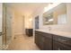Modern bathroom featuring double vanity, glass shower, and neutral tiling at 10586 Jacks Way, Indianapolis, IN 46234