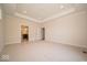 Bright bedroom with recessed lights, tray ceiling, neutral carpet and attached bathroom at 10586 Jacks Way, Indianapolis, IN 46234