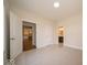 This bedroom boasts neutral carpet, two windows, and views into the kitchen and bathroom at 10586 Jacks Way, Indianapolis, IN 46234