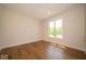 Cozy bedroom featuring hardwood floors and a bright window view at 10586 Jacks Way, Indianapolis, IN 46234