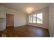 Open dining room with wood floors and large windows providing natural light and neighborhood views at 10586 Jacks Way, Indianapolis, IN 46234