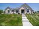 Beautifully landscaped, single-story white brick home featuring a manicured lawn at 10586 Jacks Way, Indianapolis, IN 46234
