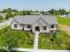 Aerial view of a white brick home with manicured landscaping and a paved walkway at 10586 Jacks Way, Indianapolis, IN 46234