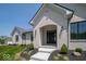 Charming front entrance with white brick, landscaped garden, and a covered doorway at 10586 Jacks Way, Indianapolis, IN 46234