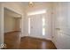 Inviting foyer with hardwood floors, a white front door, and ample natural light at 10586 Jacks Way, Indianapolis, IN 46234