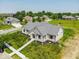 Stunning home featuring a gray roof, a well-manicured lawn, and elegant landscaping at 10586 Jacks Way, Indianapolis, IN 46234