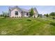Beautifully landscaped front yard with green grass and a well-maintained garden at 10586 Jacks Way, Indianapolis, IN 46234