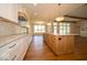 Bright kitchen with a wooden island and stainless steel appliances, open to living room and dining area at 10586 Jacks Way, Indianapolis, IN 46234