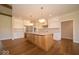 Spacious kitchen with stainless steel appliances, a large island with wooden cabinets, and white countertops at 10586 Jacks Way, Indianapolis, IN 46234