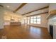 Bright living room with wood floors, wooden beams, fireplace and large windows with lots of natural light at 10586 Jacks Way, Indianapolis, IN 46234