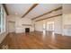 Open concept living room featuring hardwood floors, a fireplace, and a large window at 10586 Jacks Way, Indianapolis, IN 46234
