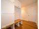 Mudroom features a bench, hooks, and storage, complemented by wood flooring at 10586 Jacks Way, Indianapolis, IN 46234