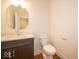 This powder room features a marble countertop and modern fixtures at 10586 Jacks Way, Indianapolis, IN 46234