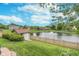 Picturesque backyard featuring a pond with fountain and a shed, all enclosed by a charming wooden fence at 10673 Misty Hollow Ln, Fishers, IN 46038