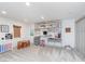 Spacious basement featuring built-in shelving, carpeting, and room for entertainment at 10673 Misty Hollow Ln, Fishers, IN 46038