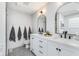 Stylish bathroom with double sinks, modern mirrors and black fixtures at 10673 Misty Hollow Ln, Fishers, IN 46038