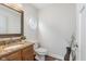 Charming powder room with granite counters and an octagon window at 10673 Misty Hollow Ln, Fishers, IN 46038