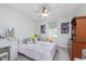 Bright bedroom with ceiling fan, window, and colorful decor at 10673 Misty Hollow Ln, Fishers, IN 46038
