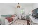 Bright bedroom featuring a comfortable daybed, desk area, and hardwood flooring at 10673 Misty Hollow Ln, Fishers, IN 46038