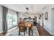 Dining area featuring modern lighting, hardwood floors, and an open kitchen at 10673 Misty Hollow Ln, Fishers, IN 46038