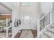 Bright foyer with a grand staircase, high ceilings, and modern accents at 10673 Misty Hollow Ln, Fishers, IN 46038