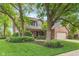 Charming two-story home with well-manicured lawn, mature trees, and brick accents at 10673 Misty Hollow Ln, Fishers, IN 46038