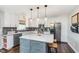 Contemporary kitchen with a gray island, stainless steel appliances, and ample storage at 10673 Misty Hollow Ln, Fishers, IN 46038