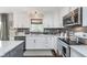 Well-lit kitchen featuring stainless steel appliances and white cabinetry at 10673 Misty Hollow Ln, Fishers, IN 46038
