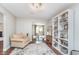 Inviting living room with stylish decor, hardwood floors, and a view into the kitchen at 10673 Misty Hollow Ln, Fishers, IN 46038