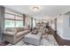 Open concept living area with hardwood floors, neutral tones, and kitchen view at 10673 Misty Hollow Ln, Fishers, IN 46038