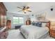 Relaxing main bedroom with a ceiling fan and large windows at 10673 Misty Hollow Ln, Fishers, IN 46038