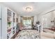 Cozy office space with built-in bookshelves and a comfortable reading nook at 10673 Misty Hollow Ln, Fishers, IN 46038