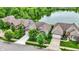 Aerial view of houses near a lake, highlighting curb appeal, green lawns, and landscaping at 1071 Serenity Ct, Carmel, IN 46280