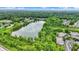 Aerial image of a community around a lake with lush green trees and cloudy sky at 1071 Serenity Ct, Carmel, IN 46280