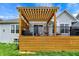 Exterior backyard view of a home featuring a wood deck with pergola and lawn at 1071 Serenity Ct, Carmel, IN 46280