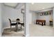 Finished basement with a dining set and recreational games offers plenty of space for entertaining at 1071 Serenity Ct, Carmel, IN 46280