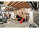 Unfinished basement featuring exposed beams, utilities, and a walk-out door at 1071 Serenity Ct, Carmel, IN 46280