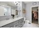 Elegant bathroom featuring double vanities, a modern shower, and a neatly organized walk-in closet for ample storage at 1071 Serenity Ct, Carmel, IN 46280