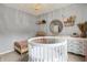 A serene Bedroom featuring a round crib, soft lighting, and calming decor, creating a soothing environment for the baby at 1071 Serenity Ct, Carmel, IN 46280