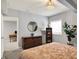 Bedroom with decorative mirror, wooden dresser, stylish lamps and ample natural light at 1071 Serenity Ct, Carmel, IN 46280