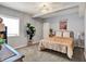 Cozy bedroom boasts a unique light fixture, a comfortable bed, and stylish decor for a serene retreat at 1071 Serenity Ct, Carmel, IN 46280