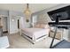 Spacious bedroom with a plush bed, modern treadmill, and a chandelier that brings a touch of elegance to the space at 1071 Serenity Ct, Carmel, IN 46280