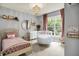 Lovely bedroom with a crib, a bed and natural light at 1071 Serenity Ct, Carmel, IN 46280
