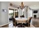 Charming dining area with a wood chandelier and access to the outdoor patio with lake view at 1071 Serenity Ct, Carmel, IN 46280