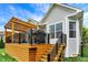 Side view of the home with a wooden deck and staircase leading down to the yard at 1071 Serenity Ct, Carmel, IN 46280