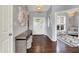 Inviting foyer featuring hardwood floors, a stylish console table, and an open view into a bright, adjacent sitting room at 1071 Serenity Ct, Carmel, IN 46280