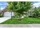 Charming brick home with a well-manicured front yard, mature trees, and a two-car garage at 1071 Serenity Ct, Carmel, IN 46280