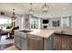 Kitchen island with granite countertop, stainless steel appliances, and view of the living room at 1071 Serenity Ct, Carmel, IN 46280