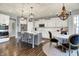 Well-equipped kitchen with an island, stainless steel appliances, and adjacent dining area at 1071 Serenity Ct, Carmel, IN 46280