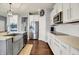 Well-appointed kitchen featuring modern appliances, granite countertops and white subway tile backsplash at 1071 Serenity Ct, Carmel, IN 46280